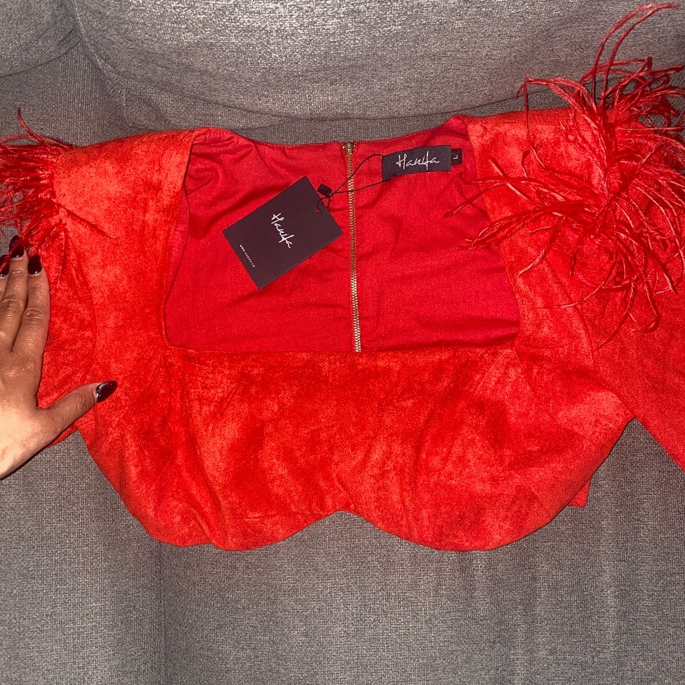 Beautiful red fashion crop top with feathers covering the shoulders f